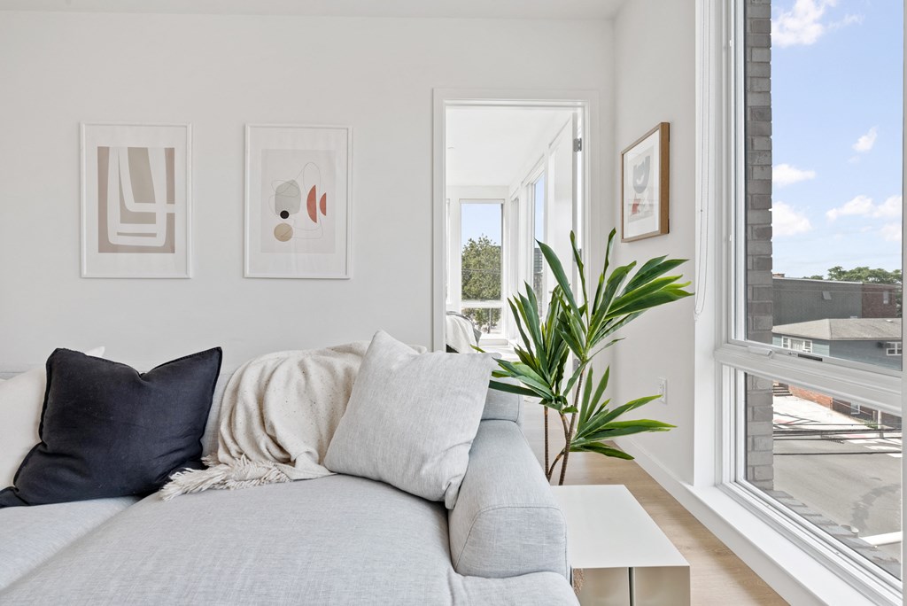 a living room with a couch and a window