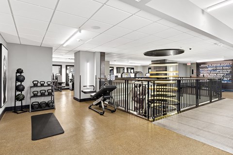 a workout room with weights and other exercise equipment