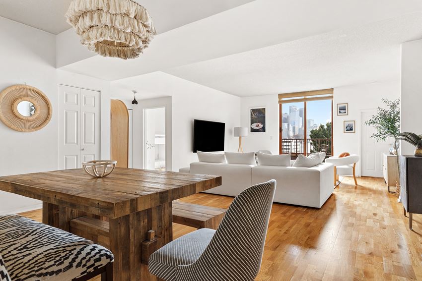a living room with a wooden dining table and white couches - Photo Gallery