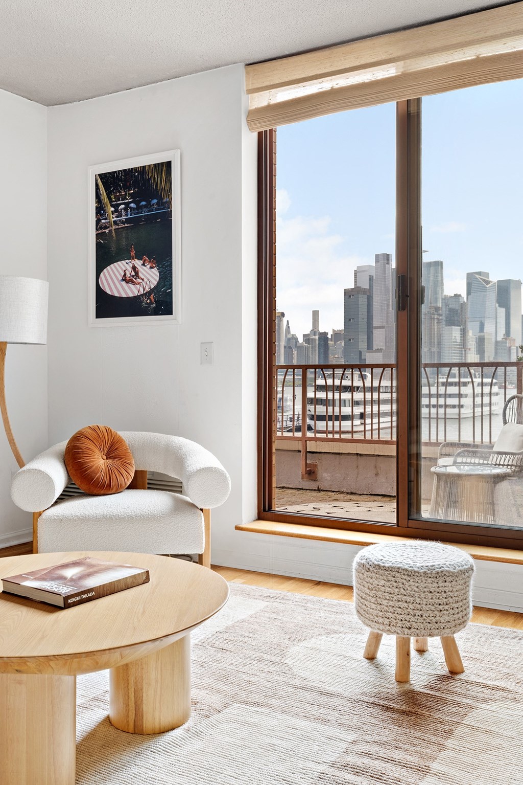 a living room with a large window and a view of the city