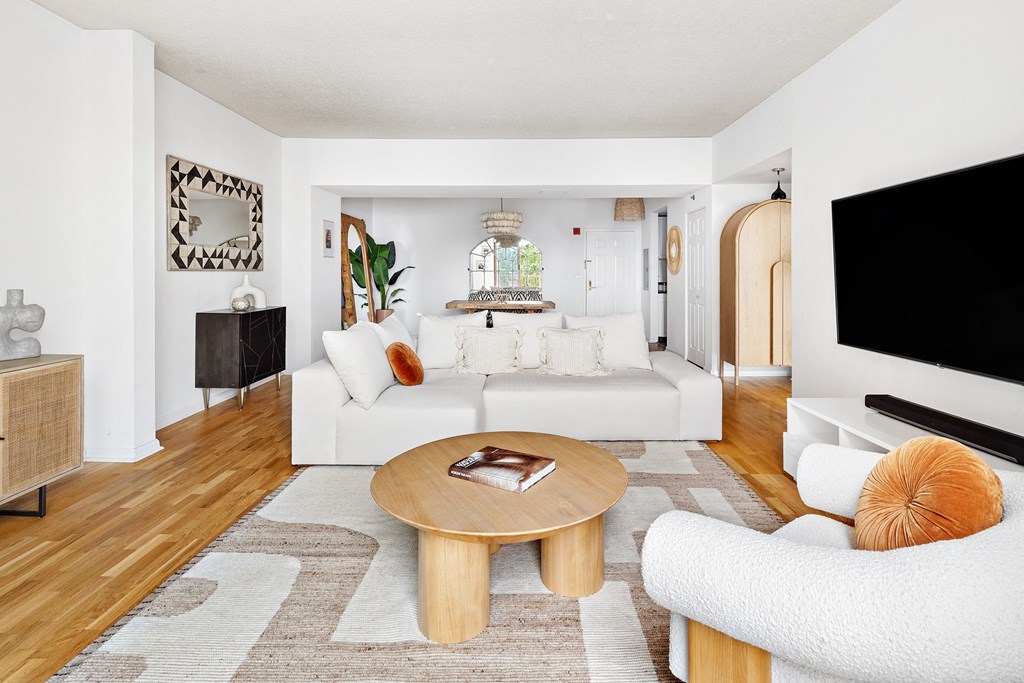 a living room filled with furniture and a flat screen tv
