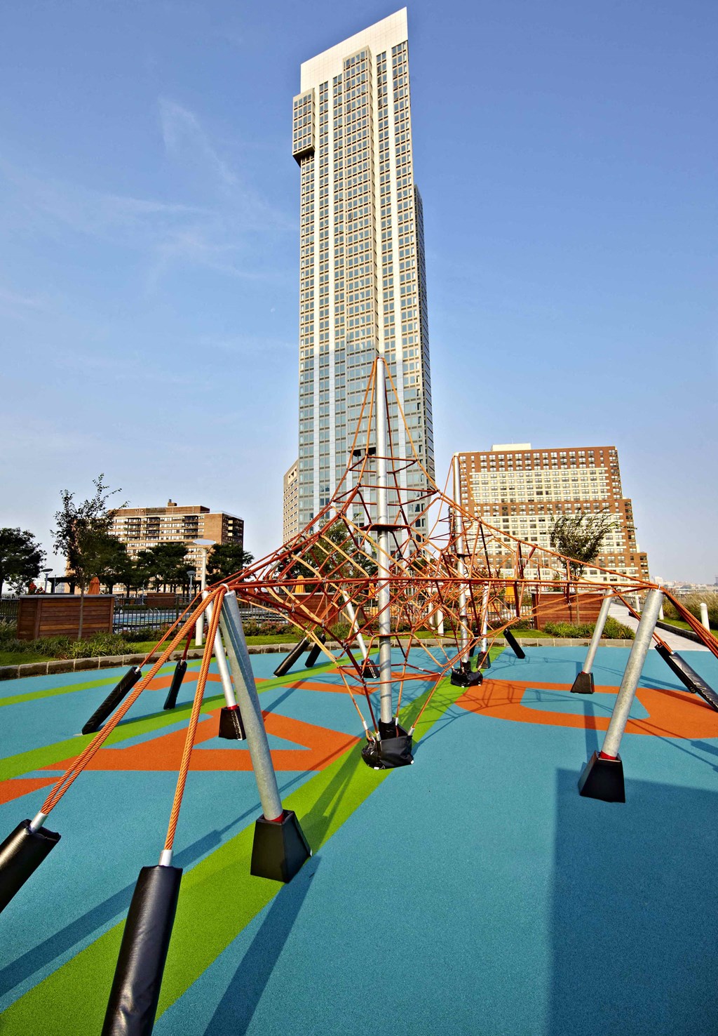 a playground in front of a skyscraper