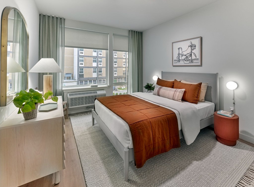 a bedroom with a bed and a large window