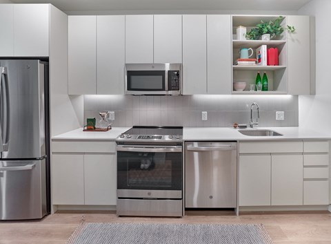 a kitchen with stainless steel appliances and white cabinets