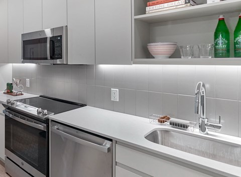 a kitchen with a sink and a stove and a microwave