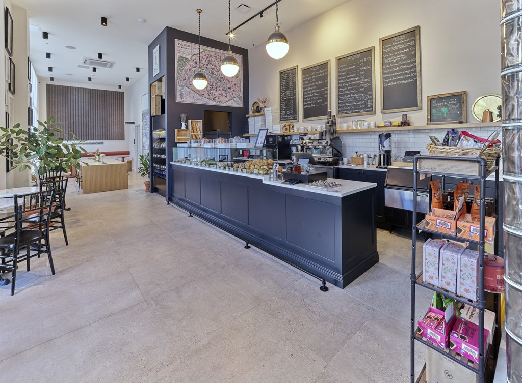a coffee shop with a long counter in the center of the room