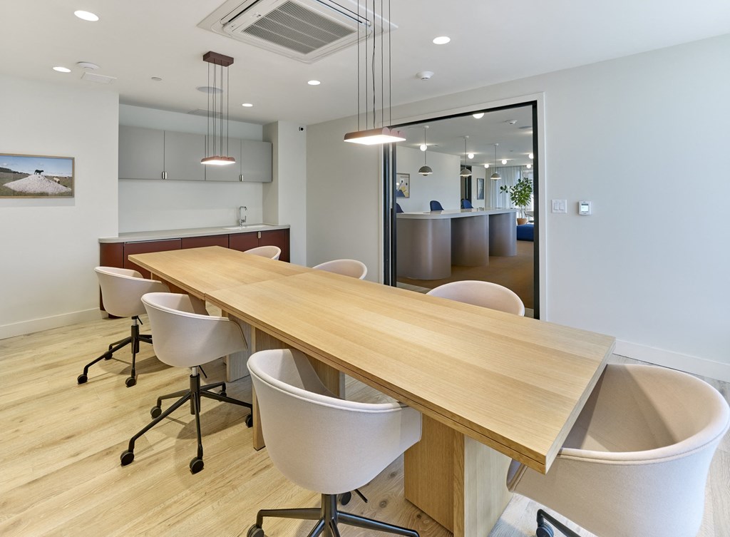 a conference room with a wooden table and chairs