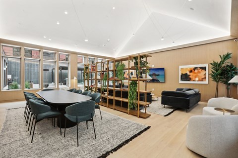 a living room with a table and chairs and a large window
