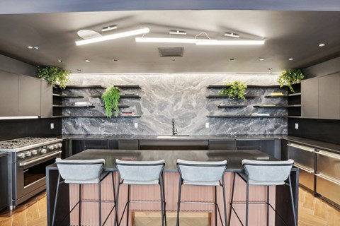 a kitchen with a marble counter top and bar stools