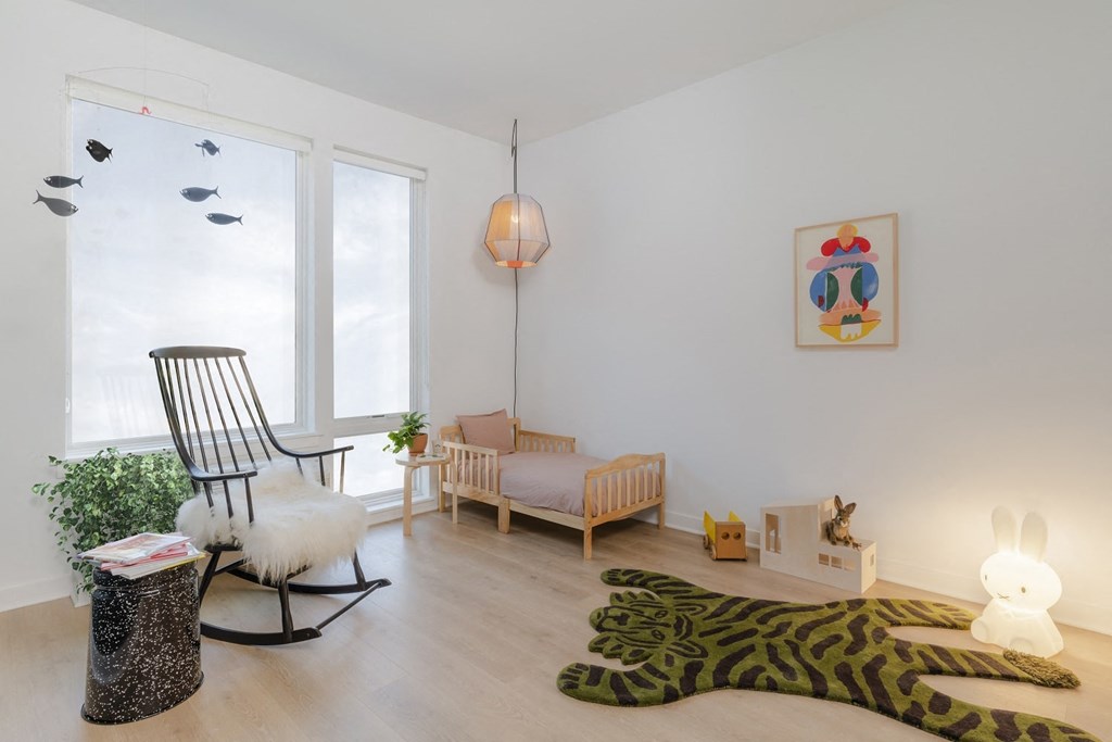 a room with a rocking chair and a zebra rug