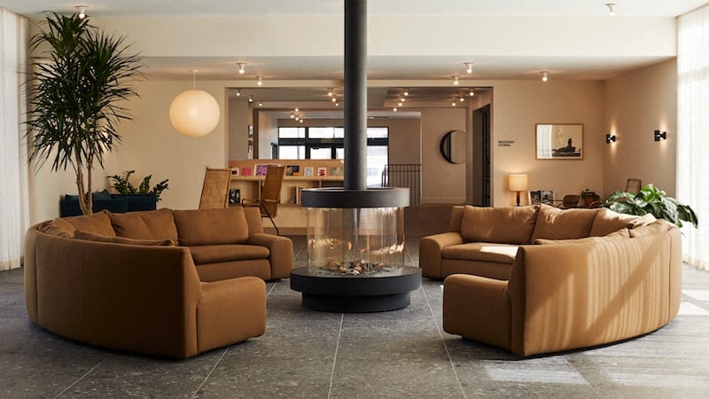 a living room with couches and a fire pit