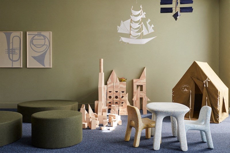 a childs play room with wooden toys and a tent