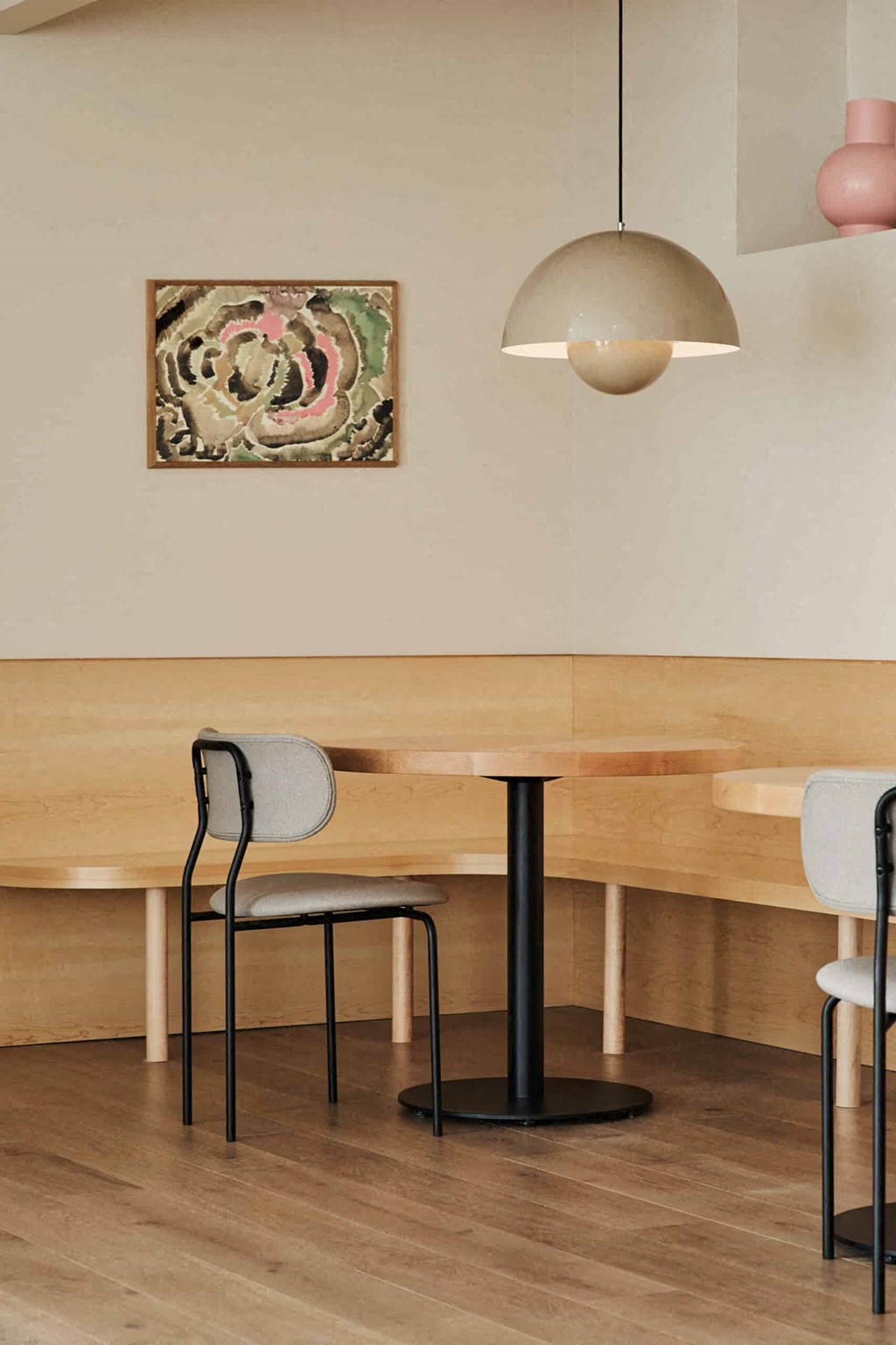 a dining room with a long wooden table and three chairs