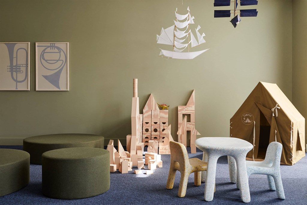 a childs playroom with wooden toys and furniture