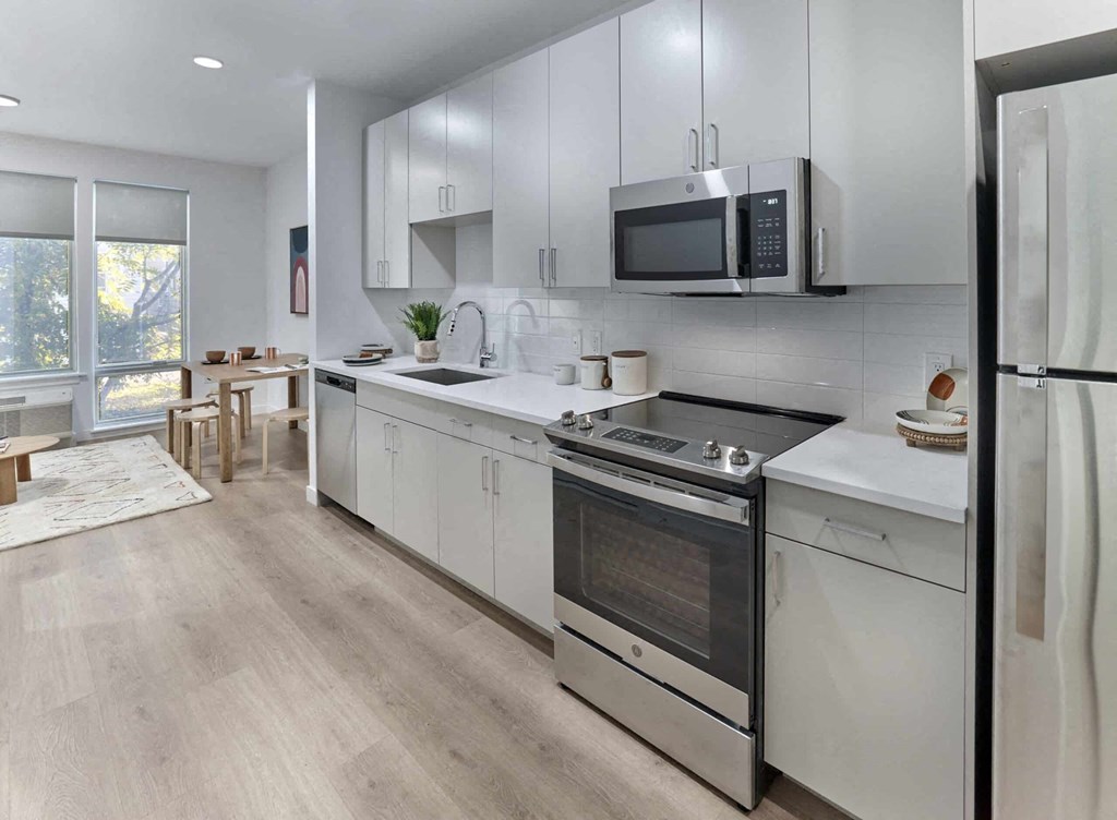 kitchen in a bedroom plus den unit.