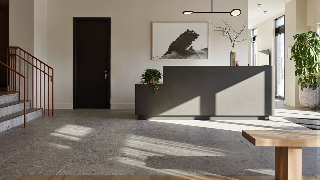 a view of the lobby with the reception desk in the foreground and the stairs in the background
