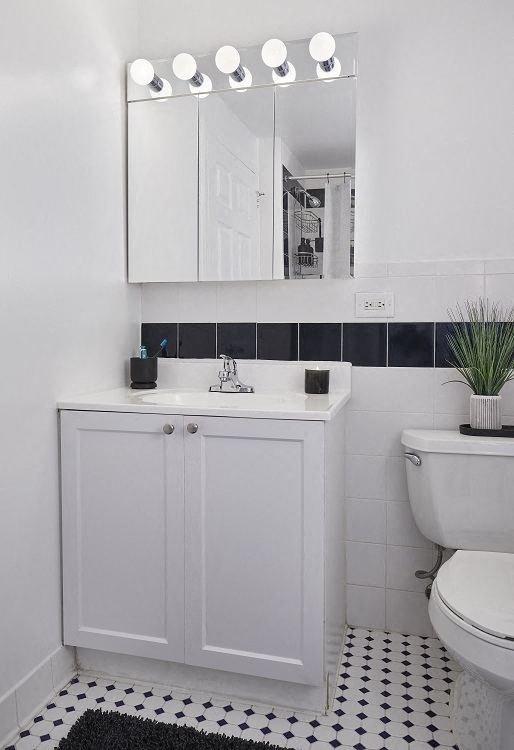 a bathroom with a toilet sink and mirror