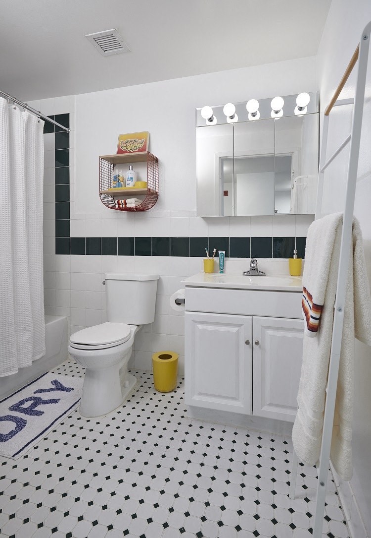 a bathroom with a white toilet next to a sink