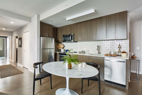 A modern kitchen with a table and chairs.