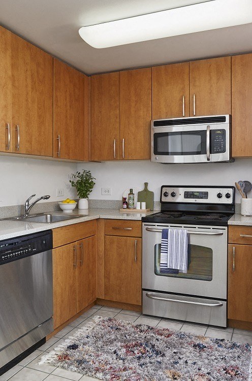 a kitchen with wooden cabinets and stainless steel appliances