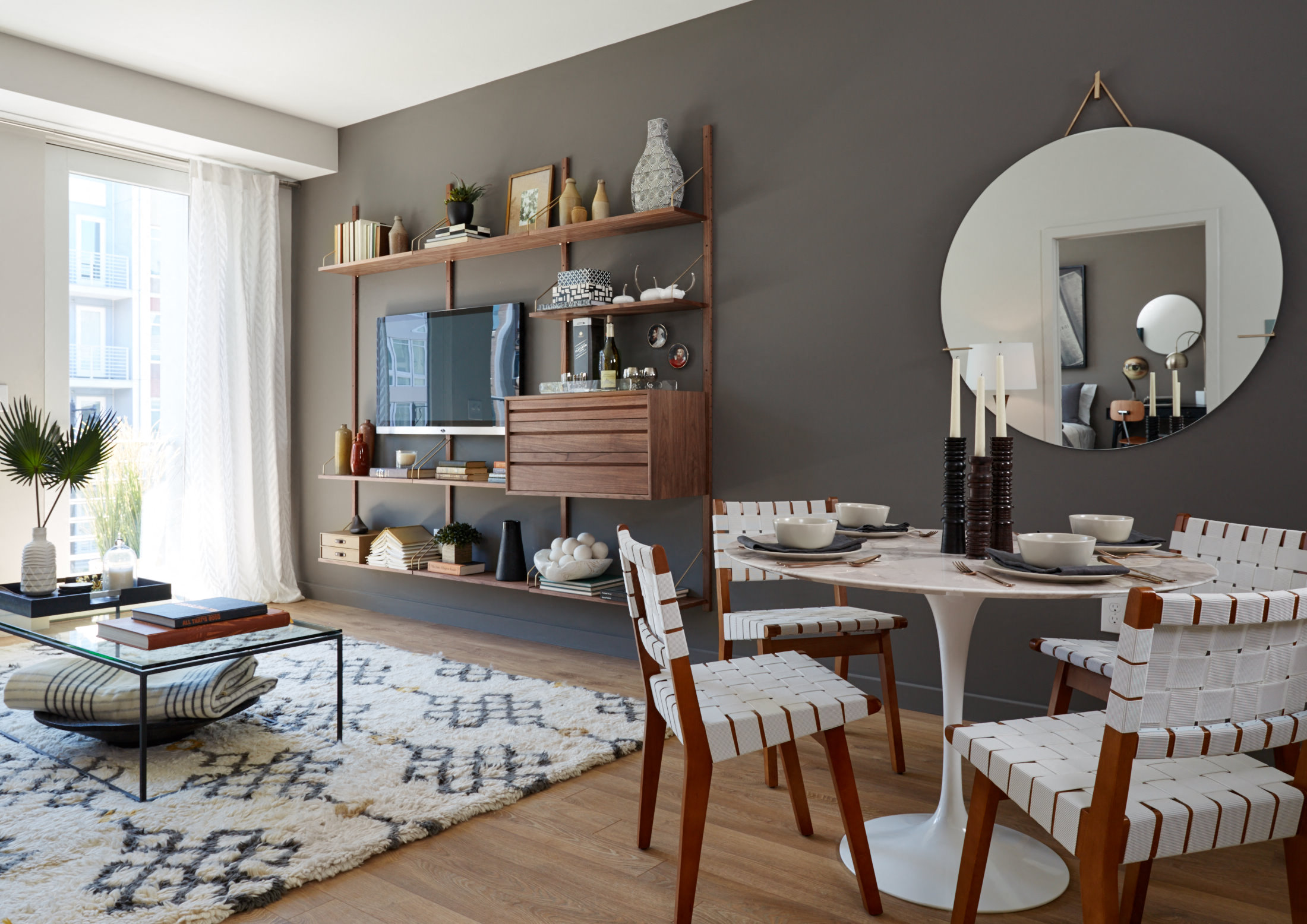 A living room with a white sofa and a coffee table with a glass top.