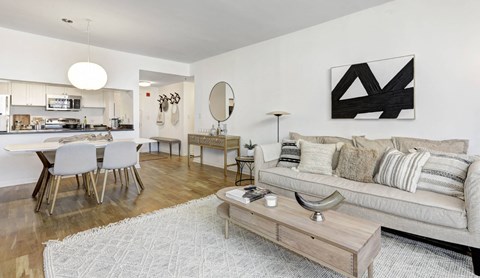 A modern living room with a grey sofa and a wooden coffee table.