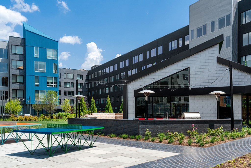 a green ping pong table in front of a building