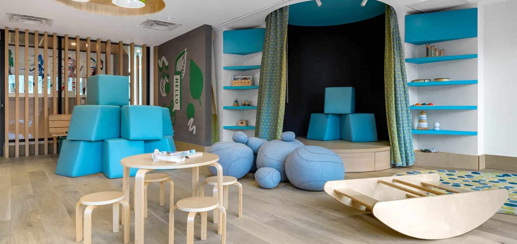 a room with blue chairs and stools