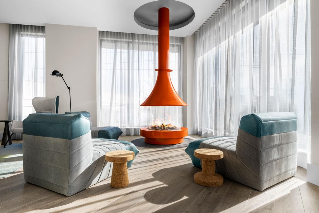 a living room with a large orange lamp hanging from the ceiling