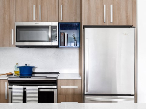 a kitchen with a stainless steel refrigerator and microwave