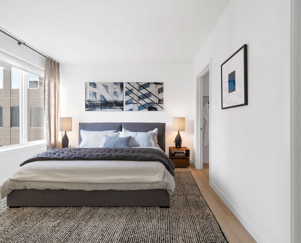 a bedroom with a large bed and a large window