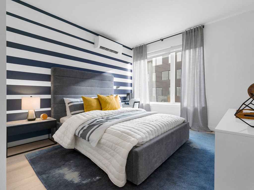 a bedroom with a large bed and a large window