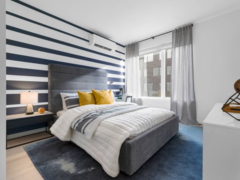 a bedroom with a large bed and a large window