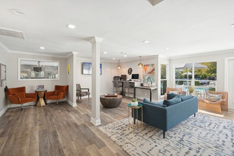 A living room with a blue couch and a wooden floor.