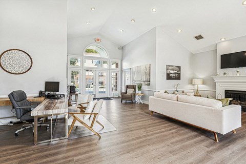 A living room with a white couch and a fireplace.
