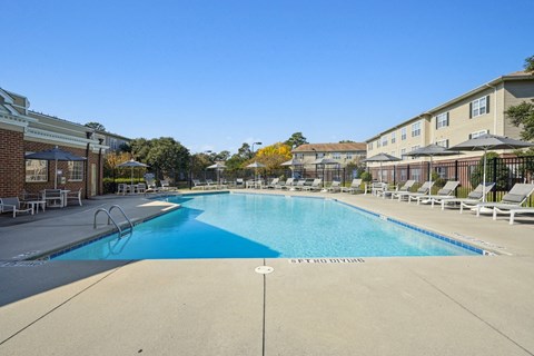 A large swimming pool with a blue bottom and a sign that says "GET OUT OF THE WATER".