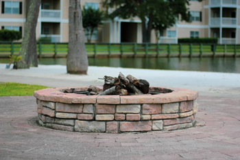 a fire pit in front of an apartment complex