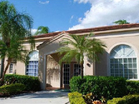 Leasing Office Exterior with Trees and Shrubs Around Sidewalk