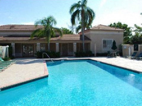 a large swimming pool in front of a house