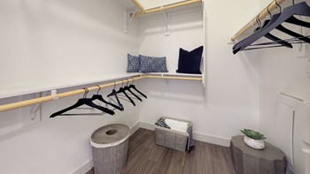 Interior of closet area with pillows and hangers stored on the shelf - Photo Gallery 48