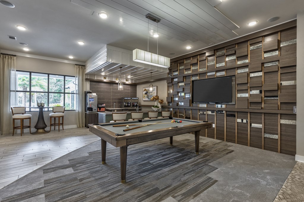 a clubhouse with a pool table and a tv