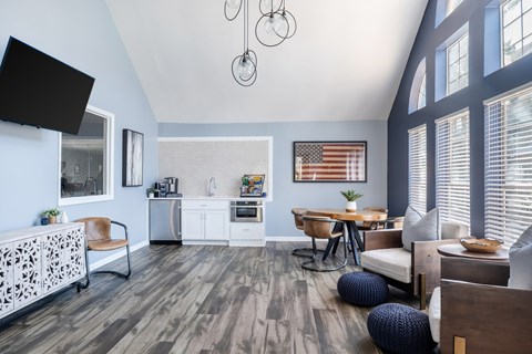 A modern kitchen with a wooden floor and a dining table with chairs.