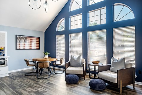 A dining room with a wooden table and chairs.
