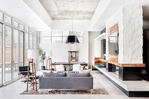 A modern living room with a grey couch and a wooden coffee table.