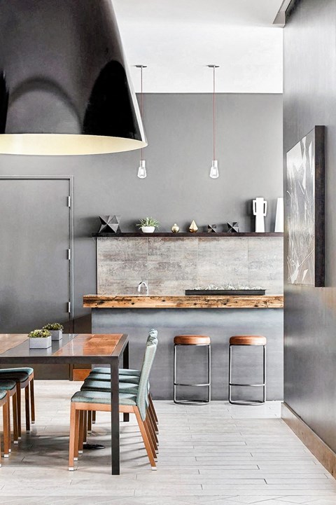 A modern kitchen with a wooden table and chairs.