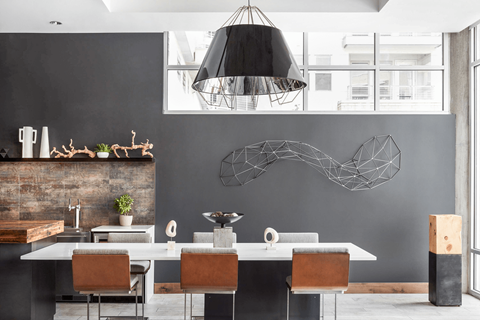 A modern dining room with a large table and chairs.