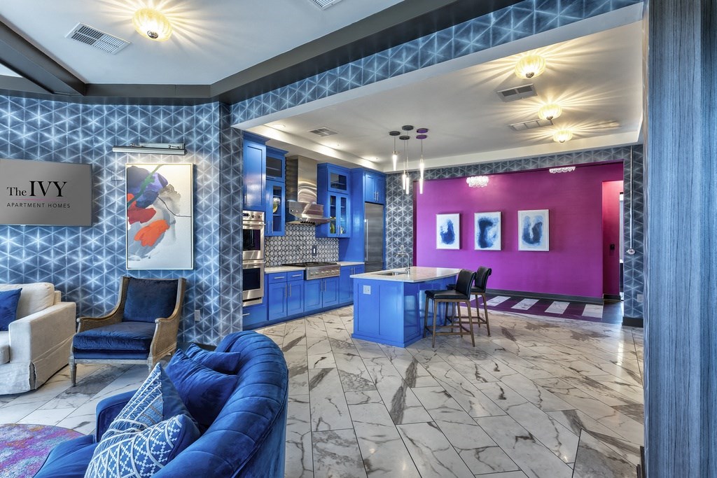 A blue couch sits in a room with a pink wall and a sign that says