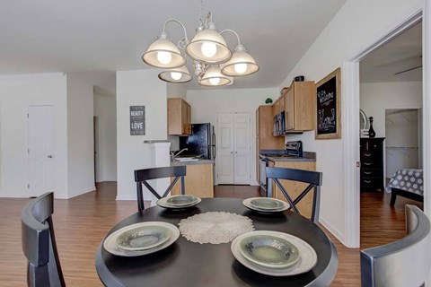 A modern dining room with a black table and chairs.