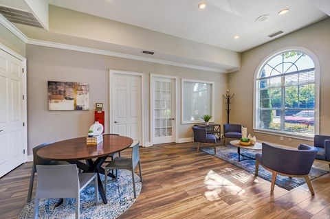 A dining room with a round table and chairs.
