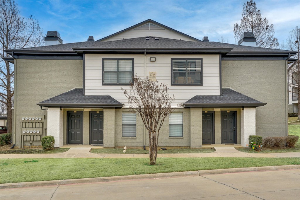 A two-story house with a gray facade and a black roof.